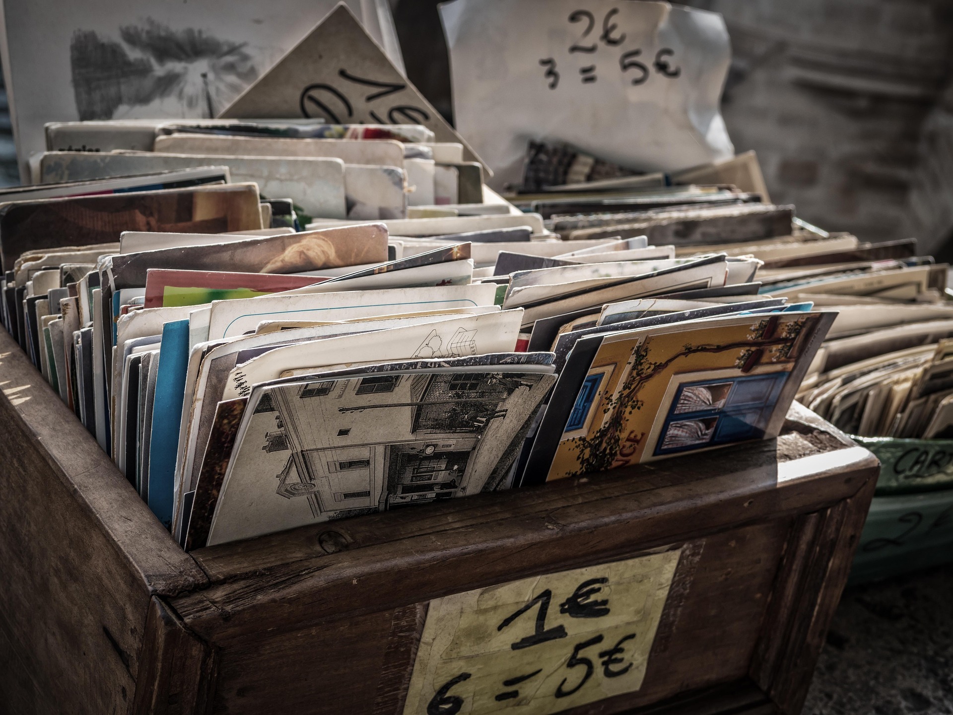 Alte Postkarten in Flohmarktkisten.