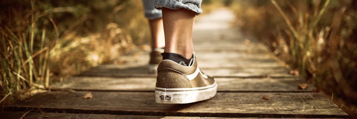 Person läuft auf einem Holzweg