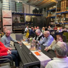 viele Menschen im Lager mit Tischen und Bänken am Essen