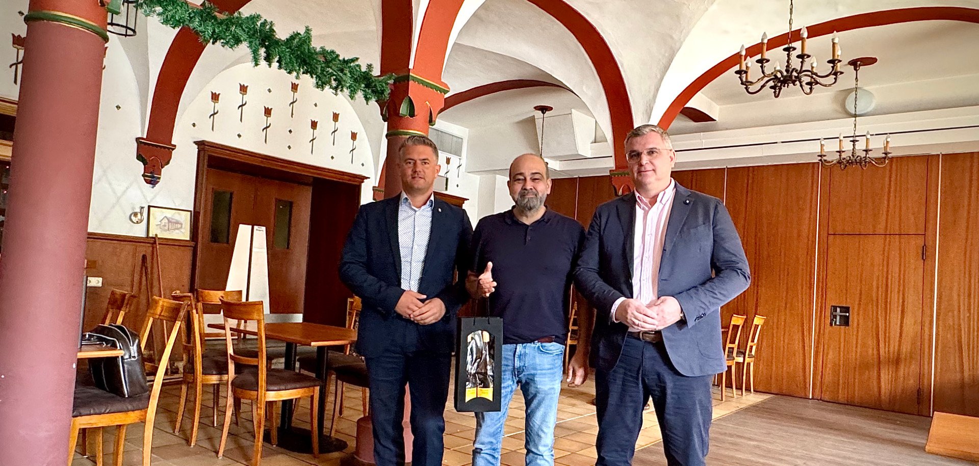 3 Männer und einem mit einem Geschenk der Stadt Alzey