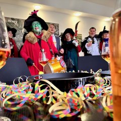 Die Alser Hexen im Rathaus neben Bürgermeister Steffen Jung, festlich verzierter Tisch mit Sekt und Luftschlangen